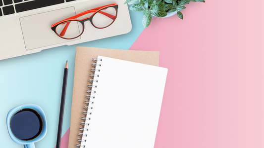 an notebook on a desk with a laptop