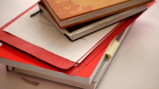 a pile of notebooks and planners